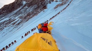 This photograph from 2021 shows mountaineers lined up as they climb a slope during their ascent to summit Mount Everest. (Lakpa Sherpa/AFP/Getty Images)
