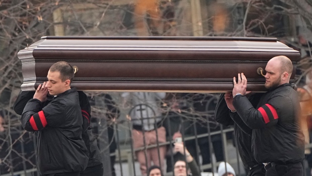 Workers carry the coffin of Russian opposition leader Alexei Navalny to the Church of the Icon of the Mother of God Soothe My Sorrows, in Moscow, Russia, Friday, March 1, 2024.  (AP Photo)
