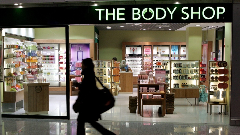 A woman passes a Body Shop cosmetics store at the airport in Frankfurt, central Germany, Friday, March 17, 2006. (AP Photo/Michael Probst)