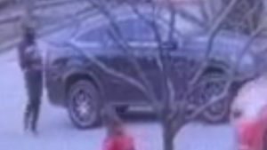 Police say photo shows the carjacking suspect standing near the victim’s black vehicle. (Peel Regional Police)