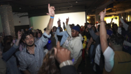 Attendees at The Cove, an 18-and-up, pop-up Christian nightclub, dance in unison on Saturday, Feb. 17, 2024, in Nashville, Tenn, where more than 200 racially and ethnically diverse young clubbers attended The Cove's fourth event. (AP Photo/Jessie Wardarski)