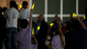 People gather on the lawn with glow sticks to send off Audrii Cunningham following a public visitation Friday, March 1, 2024, at First Baptist Church in Livingston, Texas. Audrii's body was found on the banks of the Trinity River, Feb. 20. (Yi-Chin Lee/Houston Chronicle via AP)