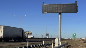 A truck passes a warning sign about the Smokehouse Creek Fire on a highway in Amarillo, Texas on Saturday, March 2, 2024. (Ty O'Neil/AP Photo)