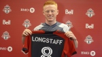 Newly-signed Toronto FC midfielder Matty Longstaff holds up his jersey after training in Toronto on Friday, March 1, 2024. Just 23, Longstaff arrives at Toronto FC with some memorable markers already on his resume. THE CANADIAN PRESS/Neil Davidson
