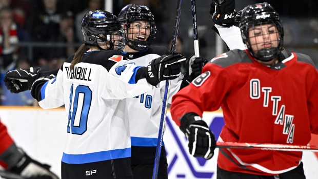 Toronto's Natalie Spooner (24) celebrates her goal with Blayre Turnbull (40) as Ottawa's Natalie Snodgrass (8) skates away, during first period PWHL hockey action in Ottawa, on Saturday, March 2, 2024. THE CANADIAN PRESS/Justin Tang