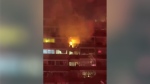 Large flames seen inside a ninth-floor unit of an apartment building in Toronto's east end. (Submitted)