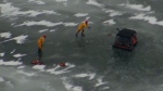 Crews work to rescue a vehicle with three occupants that fell through the ice on Lake Simcoe. (OPP Rescue screengrab)