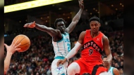 Toronto Raptors guard RJ Barrett (9) makes a pass as Charlotte Hornets forward Grant Williams (2) defends during second half NBA basketball action in Toronto on Sunday, March 3, 2024. THE CANADIAN PRESS/Frank Gunn