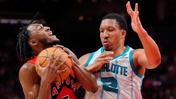 Toronto Raptors guard Immanuel Quickley (5) is fouled by Charlotte Hornets forward Grant Williams (2) during second half NBA basketball action in Toronto on Sunday, March 3, 2024. THE CANADIAN PRESS/Frank Gunn 