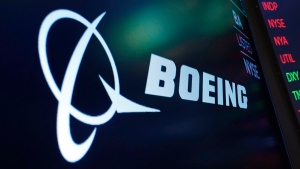 The logo for Boeing appears on a screen above a trading post on the floor of the New York Stock Exchange, July 13, 2021. (AP Photo/Richard Drew, File)