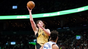 Toronto Raptors forward Kelly Olynyk (41) shoots as Golden State Warriors forward Trayce Jackson-Davis (32) looks on during second half NBA basketball action in Toronto on Friday, March 1, 2024. THE CANADIAN PRESS/Arlyn McAdorey 