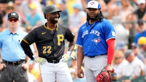 Pittsburgh Pirates designated hitter Andrew McCutchen (22) talks with Toronto Blue Jays first baseman Vladimir Guerrero Jr. after hitting a single during the first inning of a spring training baseball game Tuesday, March 5, 2024, in Bradenton, Fla. (AP Photo/Charlie Neibergall)