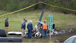 Investigators look over a small plane crash alongside eastbound Interstate 40 at mile marker 202 on Tuesday, March 5, 2024, in Nashville, Tenn. (AP Photo/George Walker IV)