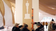 Crew members prepare the red carpet area on Wednesday, March 6, 2024, for Sunday's 96th Academy Awards at the Dolby Theatre in Los Angeles. (AP Photo/Chris Pizzello)