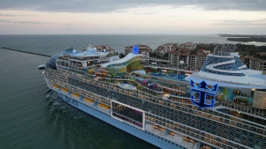 Icon of the Seas, the world's largest cruise ship, sails out of Government Cut past Fisher Island, Fla., right, as it departs PortMiami on its first public cruise, Saturday, Jan. 27, 2024. (AP Photo/Rebecca Blackwell) 