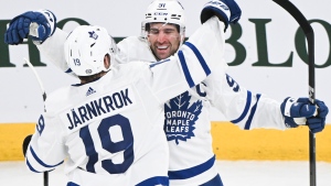 Toronto Maple Leafs' John Tavares (91) celebrates with teammate Calle Jarnkrok after scoring against the Montreal Canadiens during third period NHL hockey action in Montreal, Saturday, March 9, 2024. THE CANADIAN PRESS/Graham Hughes