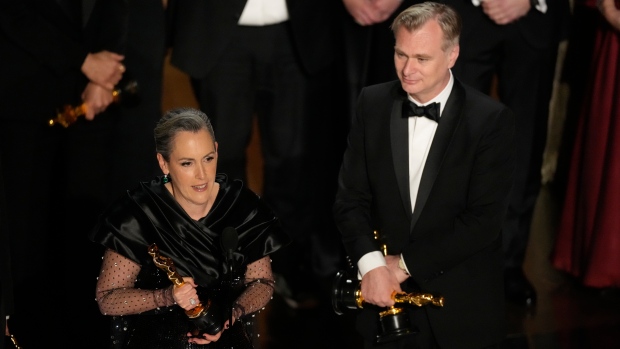 Emma Thomas, left, and Christopher Nolan accept the award for best picture for "Oppenheimer" during the Oscars on Sunday, March 10, 2024, at the Dolby Theatre in Los Angeles. (AP Photo/Chris Pizzello)