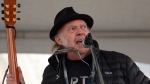 Rock legend Neil Young performs during a rally against the destruction of old growth forests in Victoria on Saturday, Feb. 25, 2023. Two years after the "Heart of Gold" musician launched a boycott of the streaming music service over vaccine misinformation on Joe Rogan's podcast, Young says he intends to end his protest and return to the platform. THE CANADIAN PRESS/Chad Hipolito