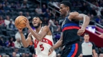 Toronto Raptors guard Immanuel Quickley (5) attempts a layup as Detroit Pistons center Jalen Duren defends during the first half of an NBA basketball game, Wednesday, March 13, 2024, in Detroit. (AP Photo/Carlos Osorio)