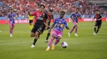 Toronto FC's Latif Blessing, right, moves the ball against Atlas FC's Jose Abella during first half Leagues Cup soccer action in Toronto, Sunday July 30, 2023. THE CANADIAN PRESS/Mark Blinch