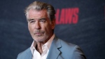 FILE - Pierce Brosnan, a cast member in "The Out-Laws," poses at a special screening of the film, June 26, 2023, at the Regal LA Live theaters in Los Angeles. (AP Photo/Chris Pizzello, File)