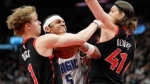 Orlando Magic forward Paolo Banchero (5) tries to drive between Toronto Raptors guard Gradey Dick (1) and teammate Kelly Olynyk (41) during second half NBA basketball in Toronto, Friday, March 15, 2024. THE CANADIAN PRESS/Frank Gunn