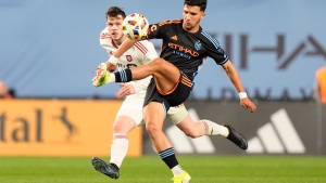 New York City FC's Monsef Bakrar, right, kicks the ball away from Toronto FC's Franco Ibarra in the first half of an MLS soccer match, Saturday, March 16, 2024, in New York. (AP Photo/Frank Franklin II)