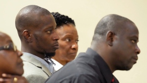 Michael Corey Jenkins, center, and Eddie Terrell Parker, right, listen as one of six former Mississippi law officers pleads guilty to state charges at the Rankin County Circuit Court in Brandon, Miss., Aug. 14, 2023. (AP Photo/Rogelio V. Solis, file)