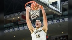 Purdue centre Zach Edey (15) dunks during second half NCAA basketball action of the 2023 Hall of Fame Series against Alabama, in Toronto, Saturday, Dec. 9, 2023. March Madness has arrived with a few Canadians looking to leave their mark. CANADIAN PRESS/Christopher Katsarov