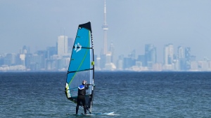 The warmest winter on record could have far-reaching effects on everything from wildfire season to erosion, climatologists say, while offering a preview of what the season could resemble in the not-so-distant future unless steps are taken to cut greenhouse gas emissions. A windsurfer cuts through the waves along Lake Ontario overlooking the City of Toronto skyline on a warm winter day in Mississauga, Ont., Friday, Feb. 9, 2024. THE CANADIAN PRESS/Nathan Denette
