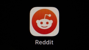 The Reddit app icon is seen on a smartphone, Feb. 28, 2023, in Marple Township, Pa. Reddit is due to begin trading on the New York Stock Exchange on Tuesday, March 21, 2024. (AP Photo/Matt Slocum, File)