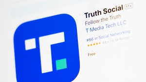 The download screen for Truth Social app is seen on a laptop computer, Wednesday, March 20, 2024, in New York. Shareholders vote Friday on a deal to merge Trump Media & Technology Group, which runs Truth Social, and Digital World Acquisition Corp.  (AP Photo/John Minchillo)