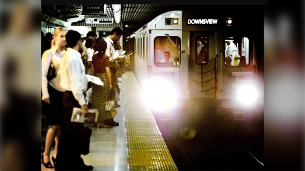 A TTC subway car arrives at the platform at the Yo