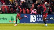 Toronto FC defender Tyrese Spicer (16) celebrates his goal against Atlanta United with teammate Aime Mabika (6) during first half MLS soccer action in Toronto on Saturday, March 23, 2024. THE CANADIAN PRESS/Arlyn McAdorey