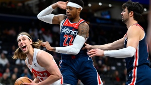 Toronto Raptors forward Kelly Olynyk, left, works against Washington Wizards forward Richaun Holmes (22) for a shot with Wizards forward Deni Avdija, right, moving in during the first half of an NBA basketball game Saturday, March 23, 2024, in Washington. (AP Photo/John McDonnell)