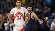 Toronto Raptors centre Jontay Porter (34) and Denver Nuggets guard Jamal Murray (27) in the second half of an NBA basketball game Monday, March 11, 2024, in Denver. THE CANADIAN PRESS/AP, David Zalubowski