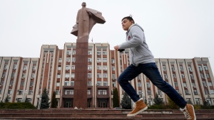 A boy runs past a statue of Soviet Union founder Vladimir Lenin in Tiraspol, the capital of the breakaway region of Transnistria, a disputed territory unrecognized by the international community, in Moldova, Monday, Nov. 1, 2021. (AP Photo/Dmitri Lovetsky) 