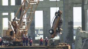 Recovery workers pull a car from the bay at the site where the Queen Isabella Causeway collapsed, in Port Isabel, Texas, Tuesday, Sept. 18, 2001. (AP Photo/Eric Gay, File)