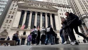 People walk past the New York Stock Exchange Wednesday, March 27, 2024. (AP Photo / Peter Morgan)