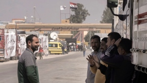 Egyptian truck drivers carrying humanitarian aids chat as they wait to cross the Rafah border crossing between Egypt and the Gaza Strip, Saturday, March.23, 2024. (AP Photo/Amr Nabil) 