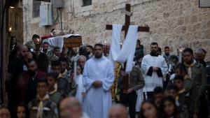 Christians carry a statue of Jesus Christ as they take part in a procession during the celebrations of the Good Friday in the Old City of Jerusalem, Friday, March 29, 2024. (AP Photo/Leo Correa) 
