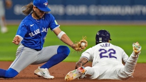 Tampa Bay Rays' Jose Siri (22) steals second base ahead of the tag by Toronto Blue Jays shortstop Bo Bichette during the sixth inning of a baseball game Friday, March 29, 2024, in St. Petersburg, Fla. (AP Photo/Chris O'Meara)