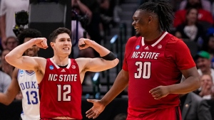North Carolina State's Michael O'Connell (12) reacts after a basket by DJ Burns Jr. (30) against Duke during the second half of an Elite Eight college basketball game in the NCAA Tournament in Dallas, Sunday, March 31, 2024. (AP Photo/Tony Gutierrez)
