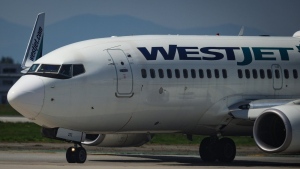 A WestJet Boeing 737-700 aircraft taxis to the runway for departure from Vancouver International Airport, in Richmond, B.C., on Friday, May 19, 2023. WestJet Encore pilots could go on strike as soon as April 17 after they approved a strike mandate Tuesday. THE CANADIAN PRESS/Darryl Dyck