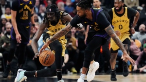 Toronto Raptors forward Mouhamadou Gueye (left) steals the ball from Los Angeles Lakers guard D'Angelo Russell (1) during first half NBA basketball action in Toronto on Tuesday, April 2, 2024. THE CANADIAN PRESS/Frank Gunn