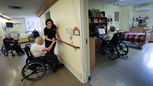 A health-care worker helps an elderly man do strength exercises at the Ivan Franko Long-term Care Home, a Ukrainian cultural home in Toronto on Wednesday, April 3, 2024. THE CANADIAN PRESS/Nathan Denette