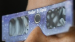 Total solar eclipses like the much anticipated one taking place next Monday are often thought of as visual experiences. A person wears a pair of NASA-approved solar eclipse glasses in Montreal, Tuesday, April 2, 2024. THE CANADIAN PRESS/Graham Hughes