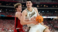 Purdue center Zach Edey, right, backs down NC State forward Ben Middlebrooks during the second half of the NCAA college basketball game at the Final Four, Saturday, April 6, 2024, in Glendale, Ariz. (AP Photo/Brynn Anderson )