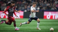 Vancouver Whitecaps' Ryan Gauld, outruns Toronto FC's Cassius Mailula, front left, and Jonathan Osorio and scores a goal during second half MLS soccer action in Vancouver, B.C., Saturday, April 6, 2024. THE CANADIAN PRESS/Darryl Dyck