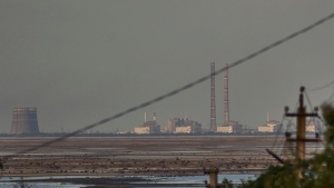 The Zaporizhzhia nuclear power plant, Europe's largest, is seen in the background of the shallow Kakhovka Reservoir after the dam collapse, in Energodar, Russian-occupied Ukraine, Tuesday, June 27, 2023.  (AP Photo/Libkos, File)